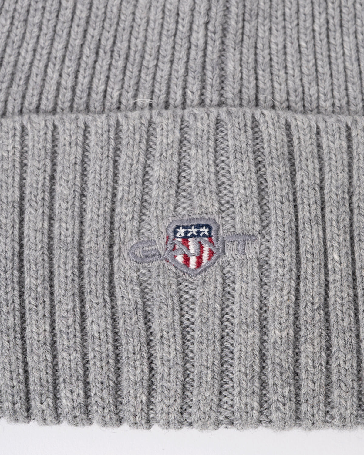 logo detail of a GANT Mens Cotton Blend Logo Beanie in 93 Grey Melange