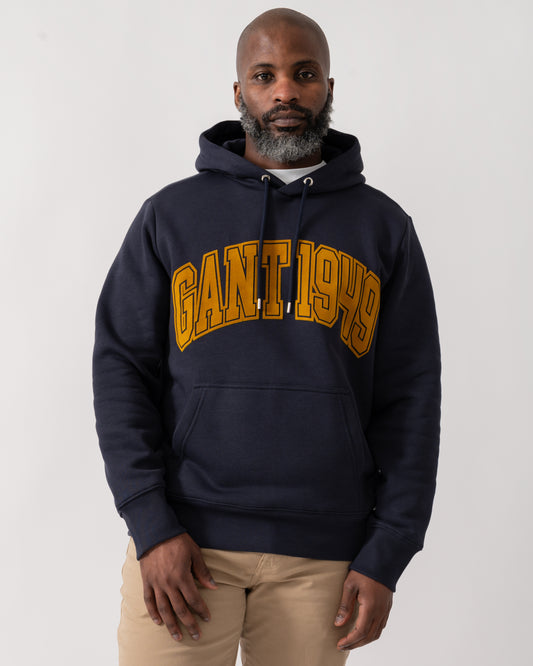 Model wearing a GANT Mens Graphic Hoodie in Evening Blue