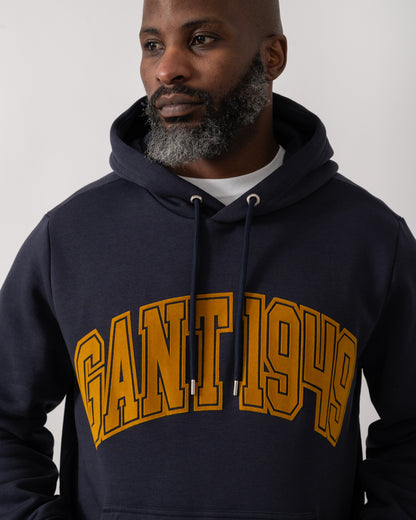 detail shot of a Model wearing a GANT Mens Graphic Hoodie in Evening Blue