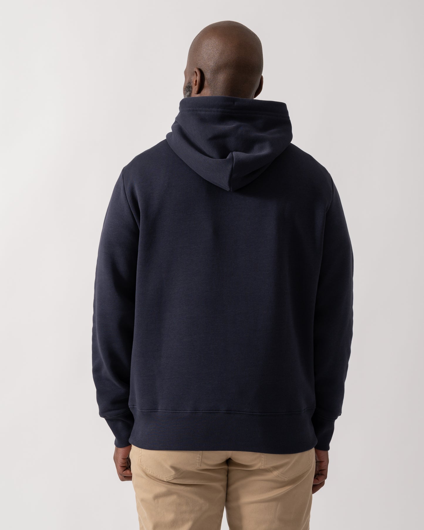 back shot of a Model wearing a GANT Mens Graphic Hoodie in Evening Blue