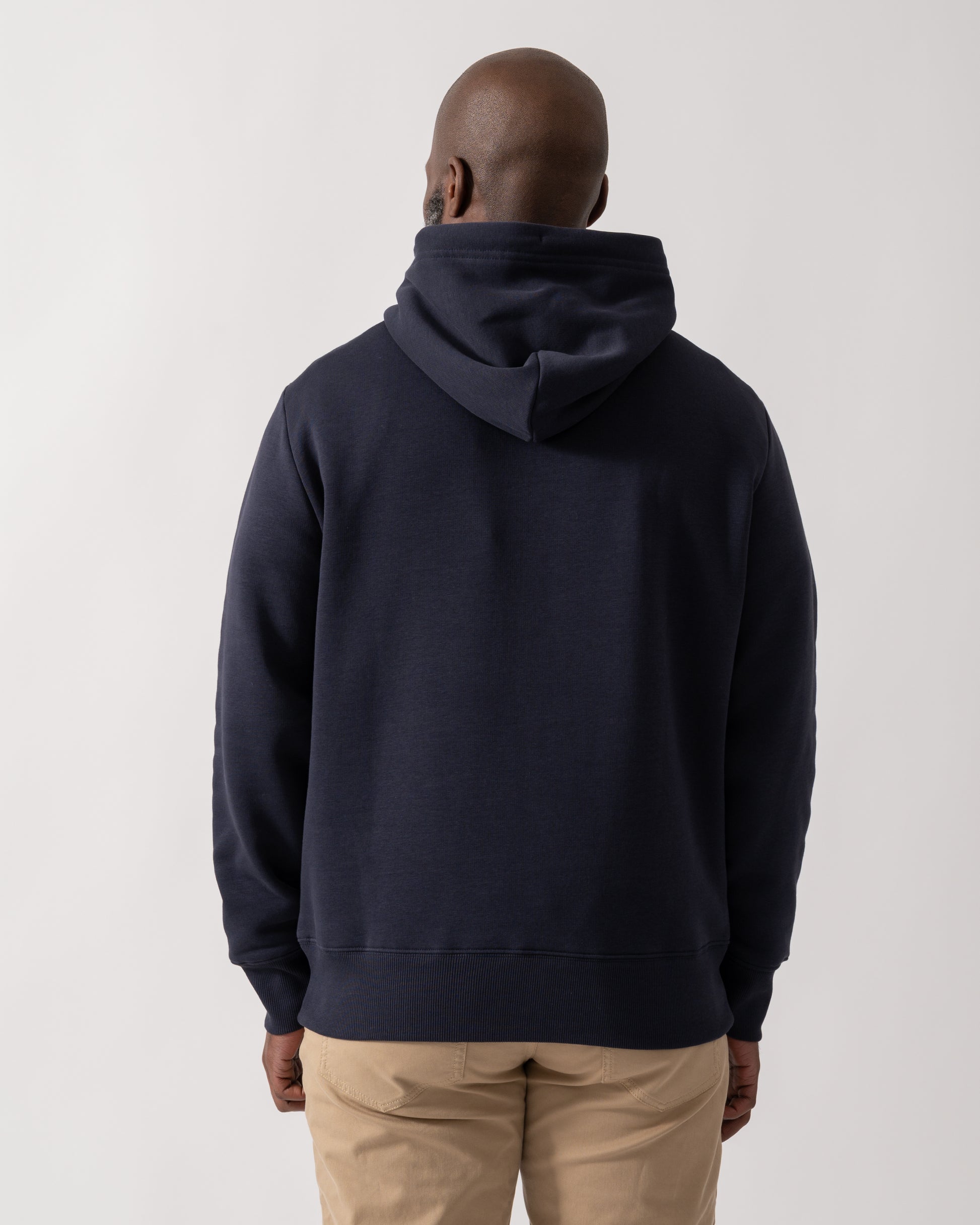 back shot of a Model wearing a GANT Mens Graphic Hoodie in Evening Blue