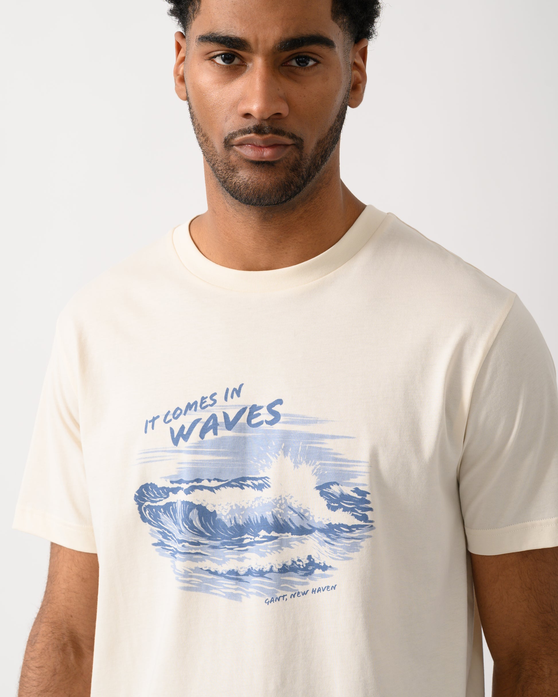 close up shot of a model wearing a GANT Mens Graphic Short Sleeve T-Shirt in 130 Cream