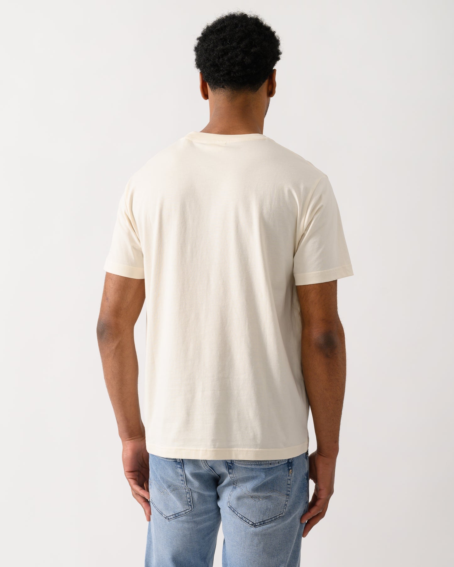 back shot of a model wearing a GANT Mens Graphic Short Sleeve T-Shirt in 130 Cream
