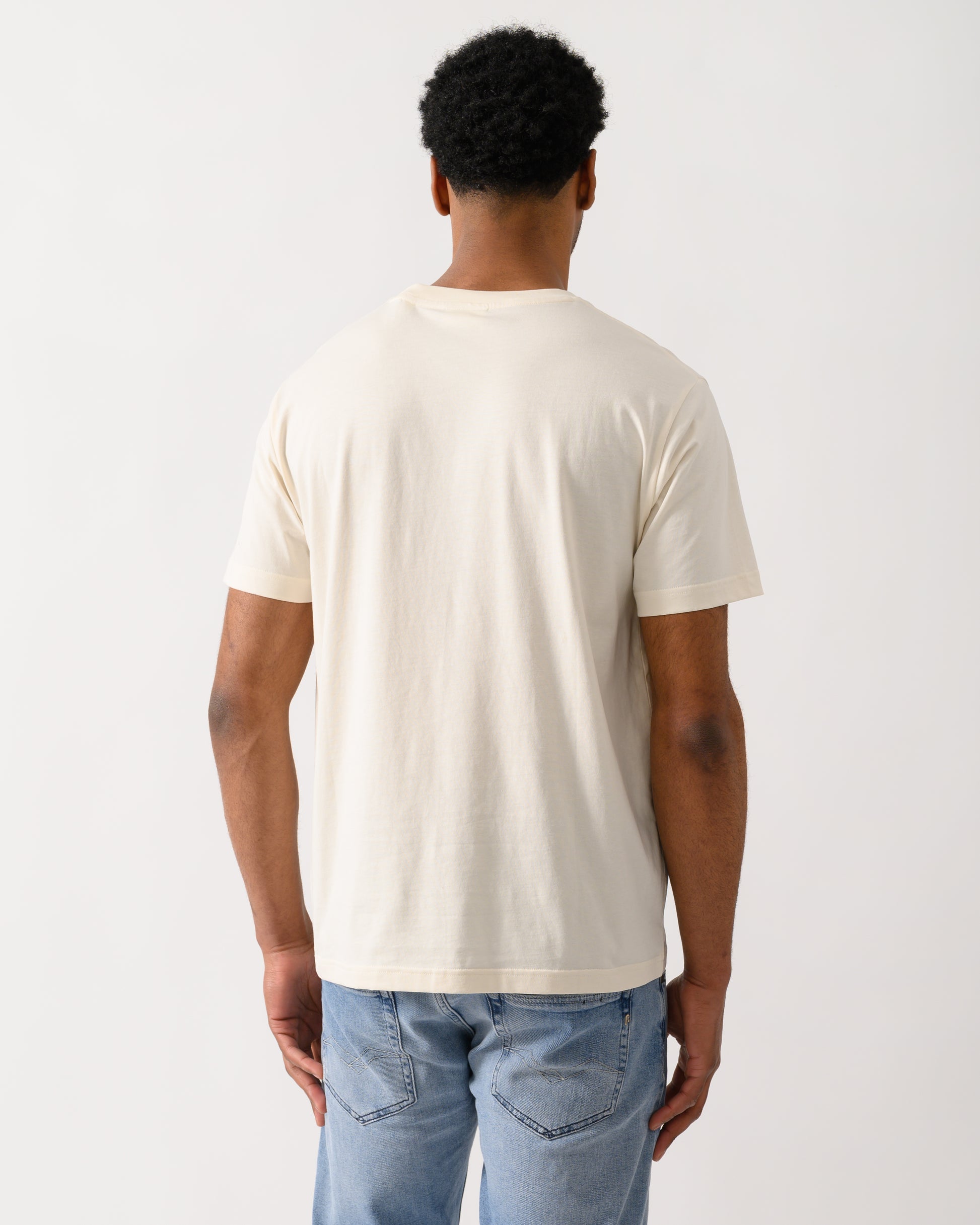 back shot of a model wearing a GANT Mens Graphic Short Sleeve T-Shirt in 130 Cream