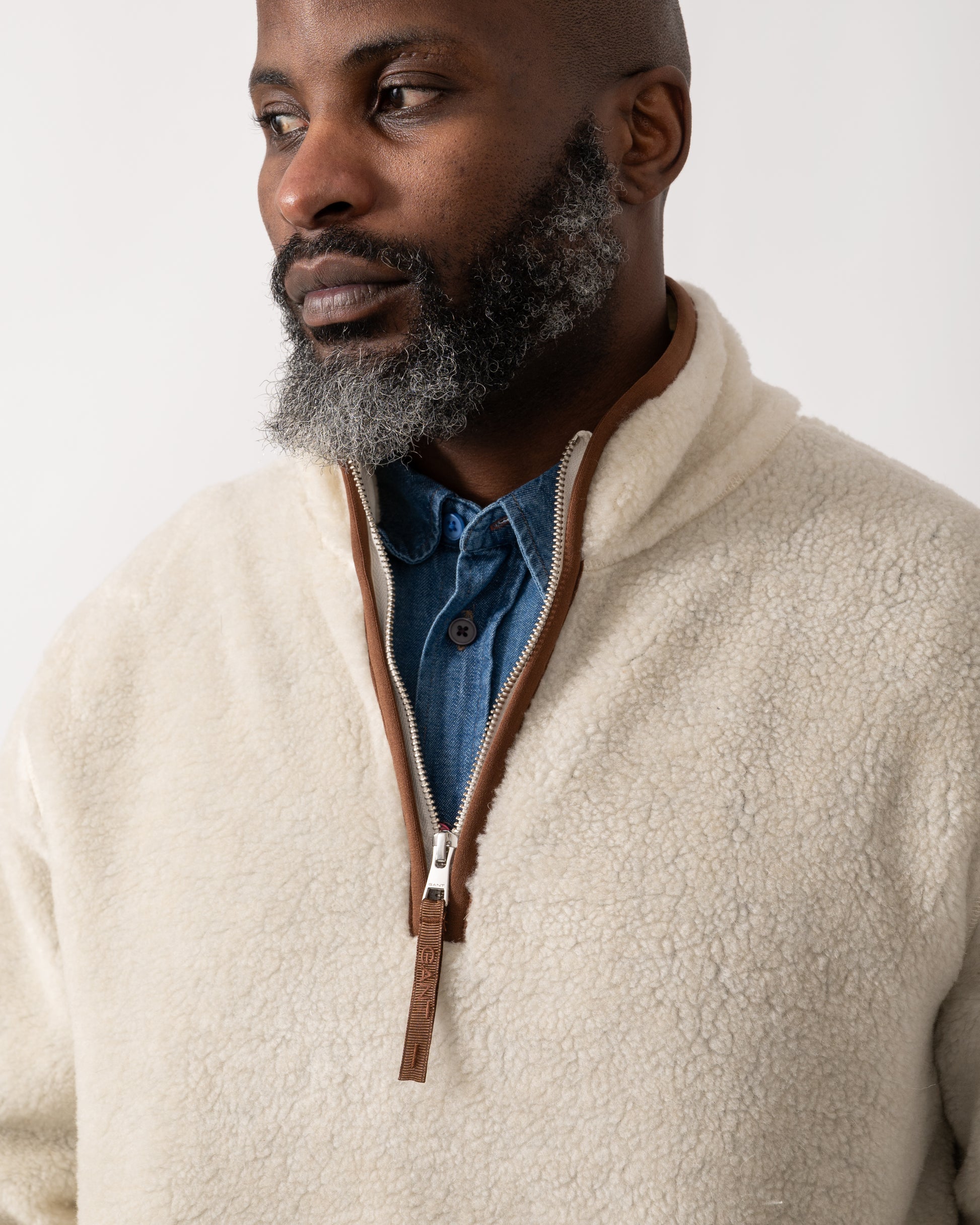 collar detail shot of a model wearing a GANT Mens Half Zip Fleece in Cream