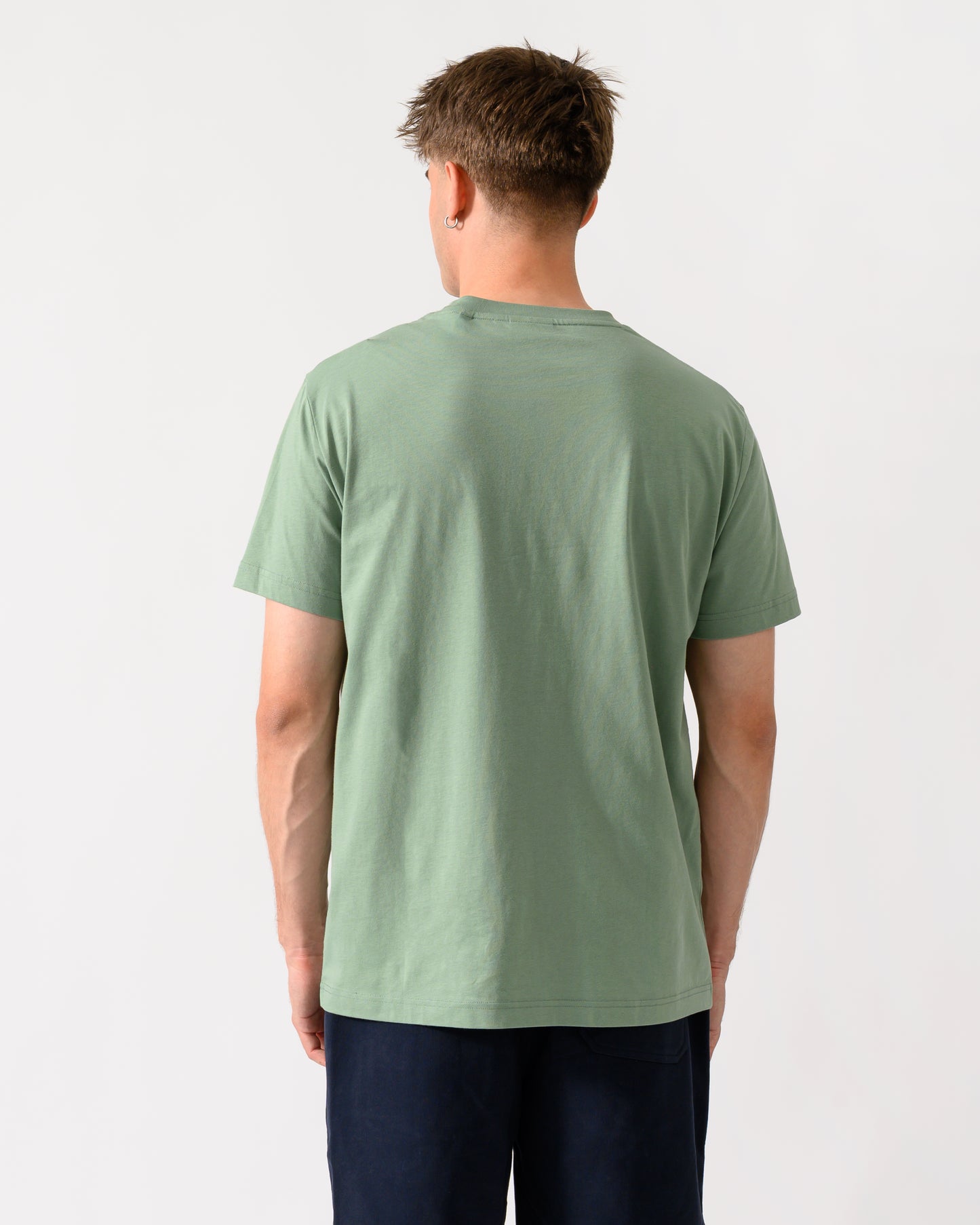 back shot of a model wearing a GANT Mens Logo Graphic Short Sleeve T-Shirt in 308 Surplus Mint