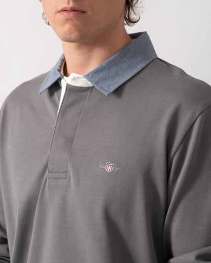 close up shot of a model wearing a GANT Mens Regular Fit Chambray Heavy Rugger in 38 Mid Grey
