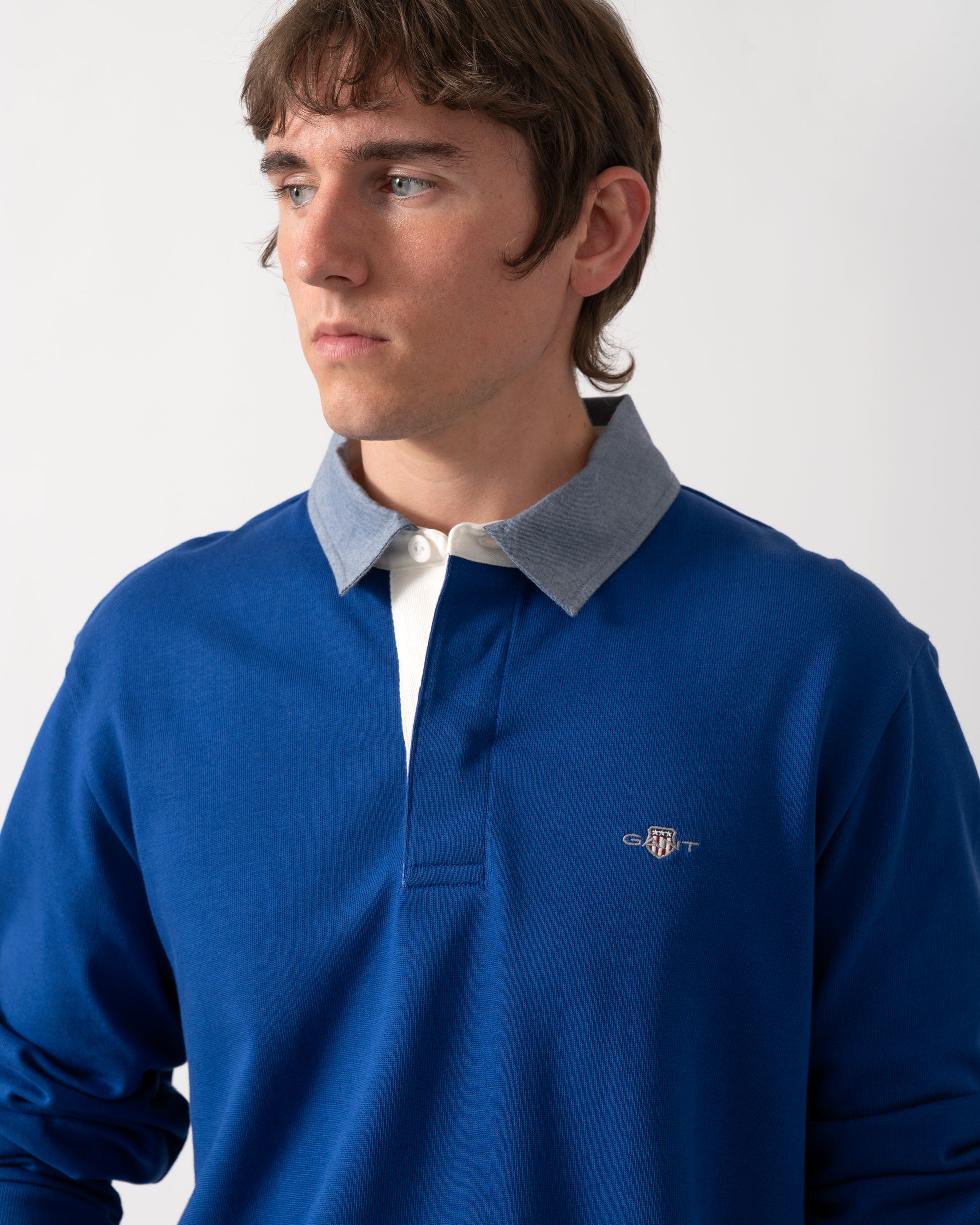 close up shot of a model wearing a GANT Mens Regular Fit Chambray Heavy Rugger in 435 Crisp Blue