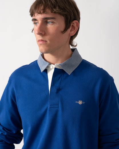 close up shot of a model wearing a GANT Mens Regular Fit Chambray Heavy Rugger in 435 Crisp Blue