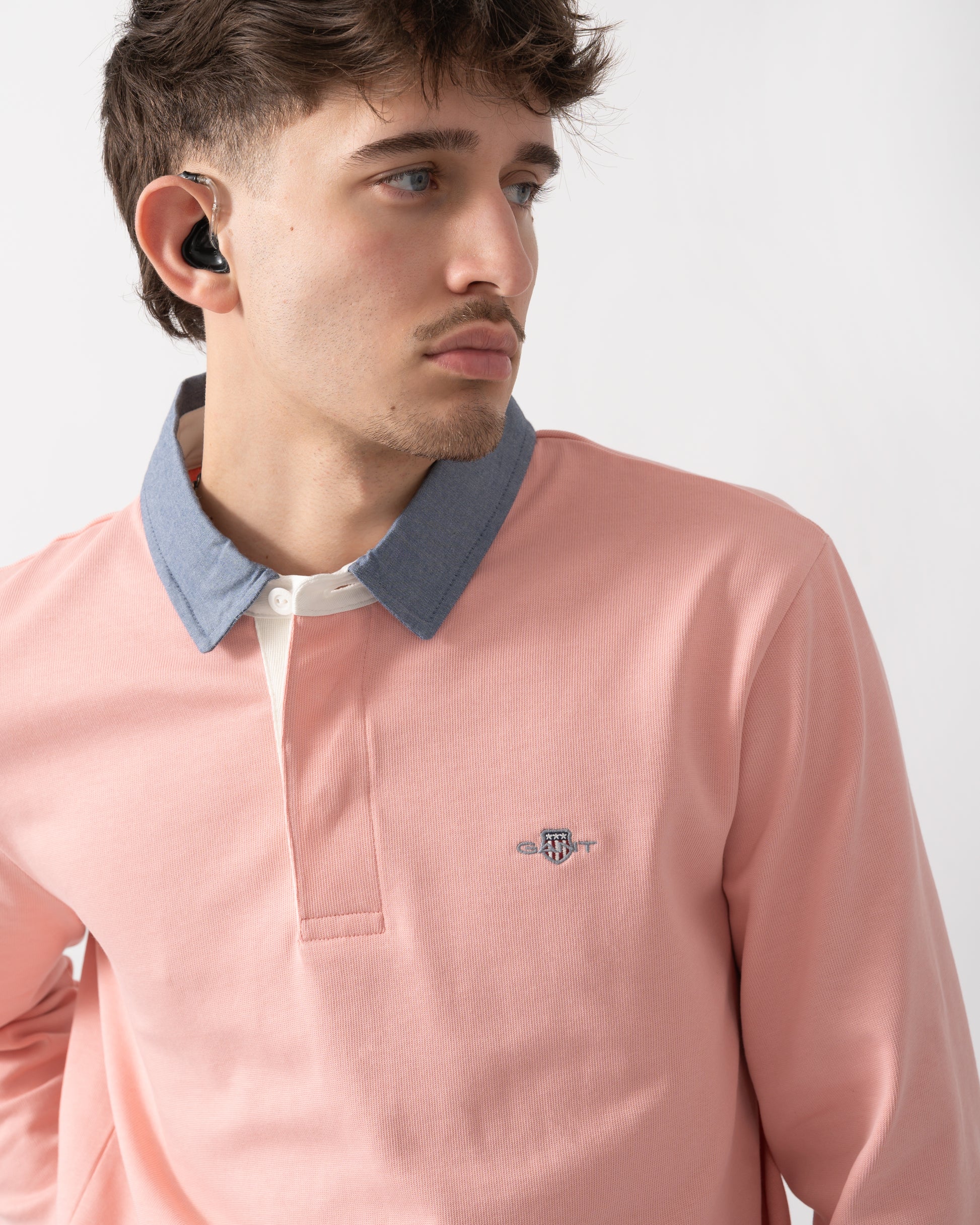 close up shot of a model wearing a GANT Mens Regular Fit Chambray Heavy Rugger in Bubblegum Pink