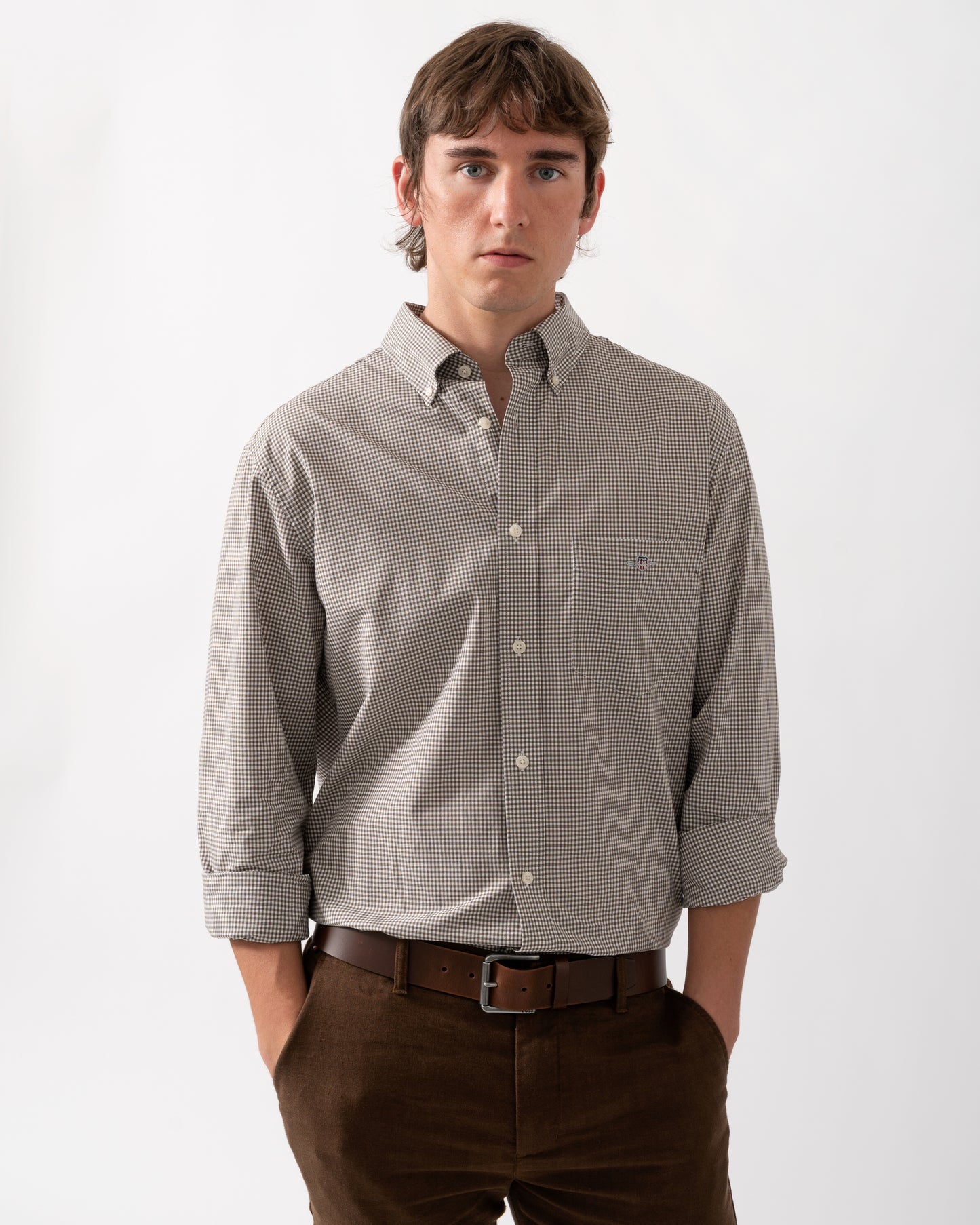 model wearing a GANT Mens Regular Fit Classic Poplin Gingham Shirt in 260 Faded Taupe