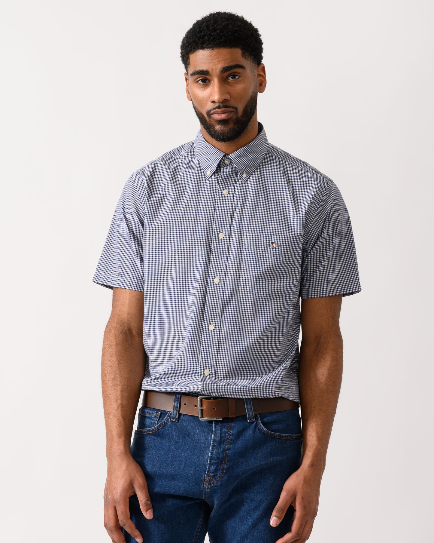 Model wearing a GANT Mens Regular Fit Classic Poplin Gingham Short Sleeve Shirt in Persian Blue
