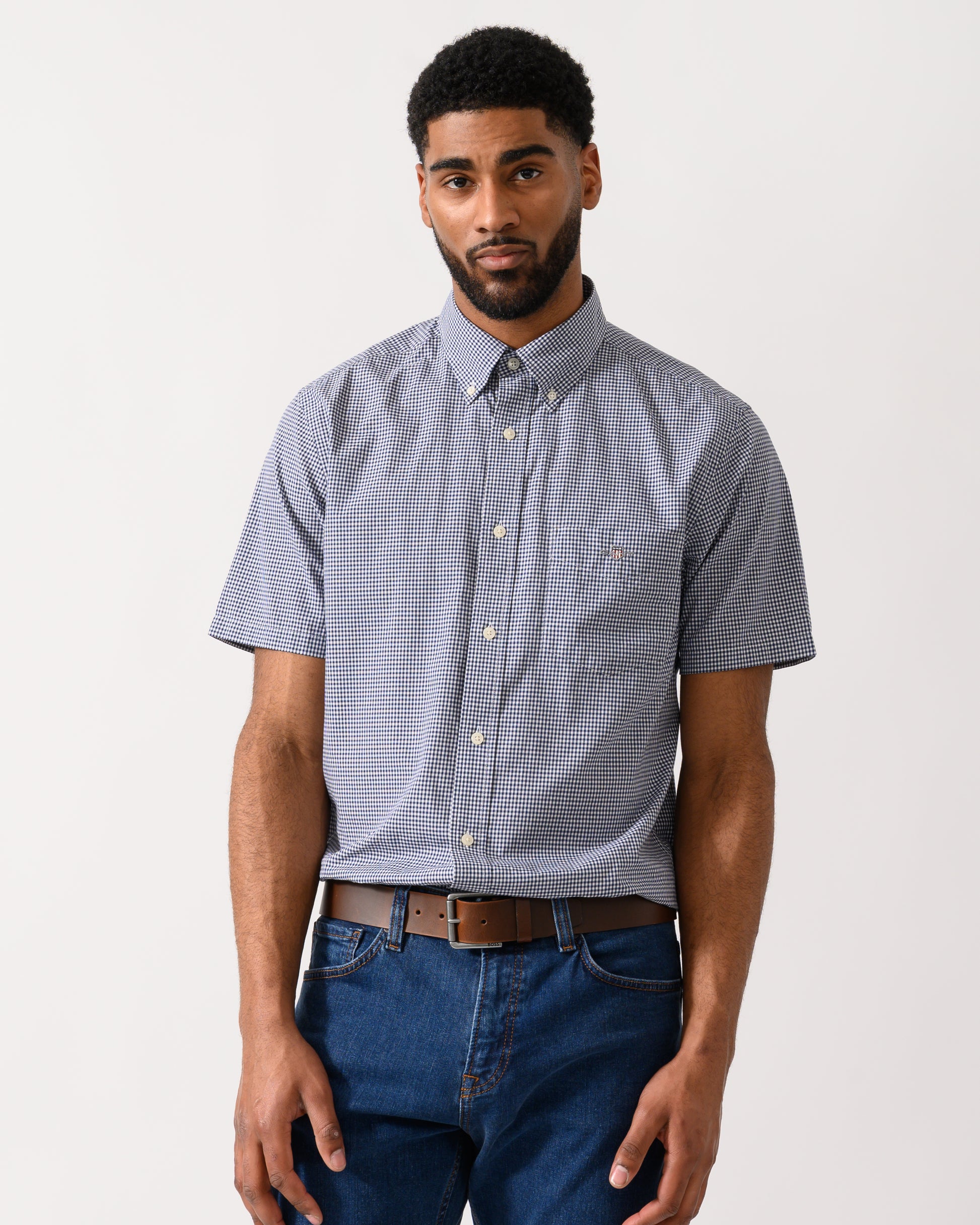 Model wearing a GANT Mens Regular Fit Classic Poplin Gingham Short Sleeve Shirt in Persian Blue