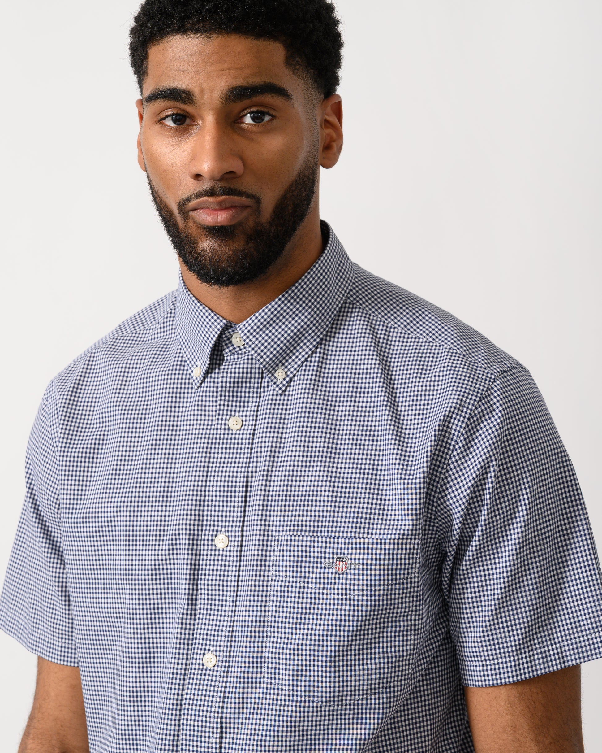 detail shot of a Model wearing a GANT Mens Regular Fit Classic Poplin Gingham Short Sleeve Shirt in Persian Blue