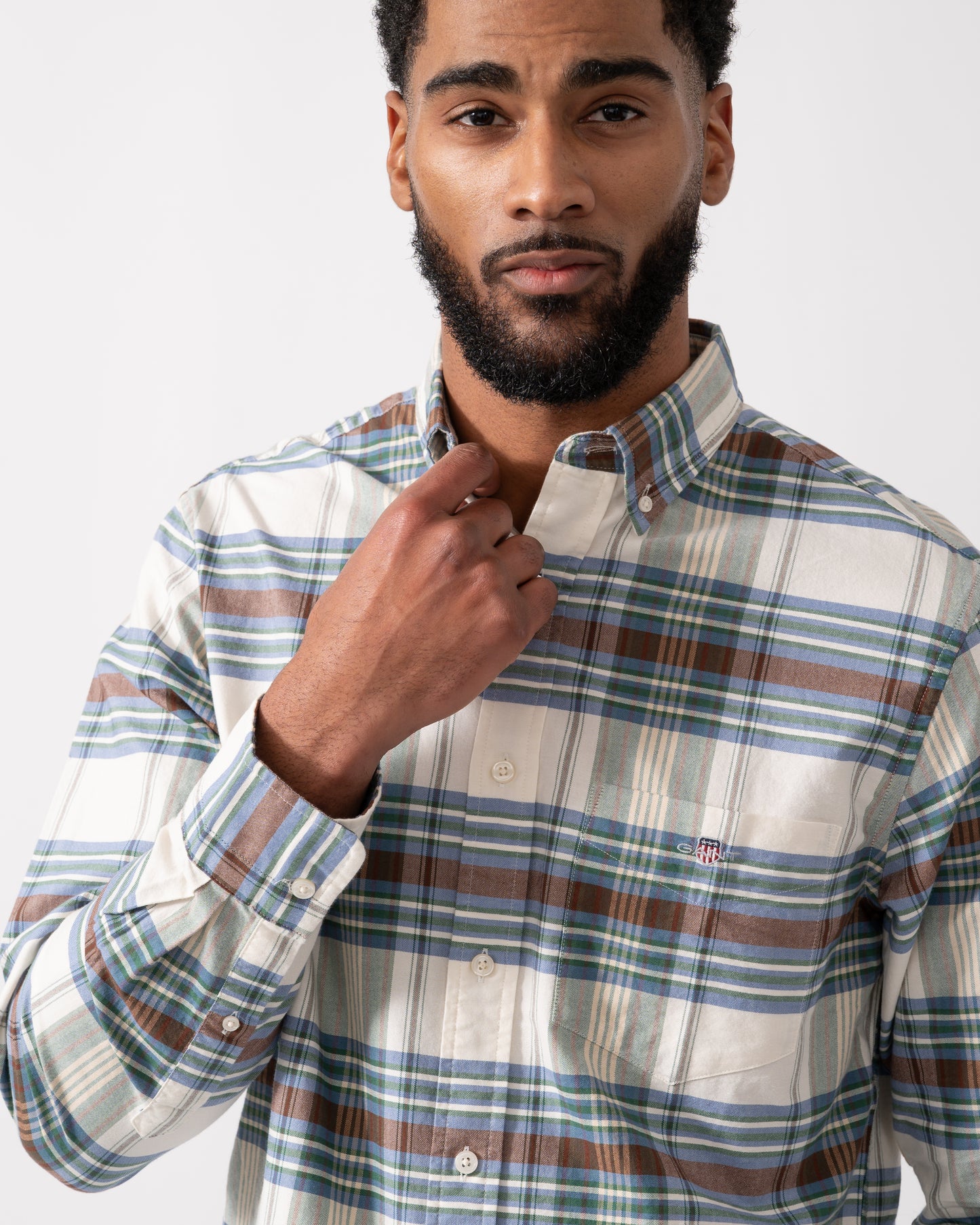 close up shot of a model wearing a GANT Mens Regular Fit Oxford Check Shirt in Woody Green