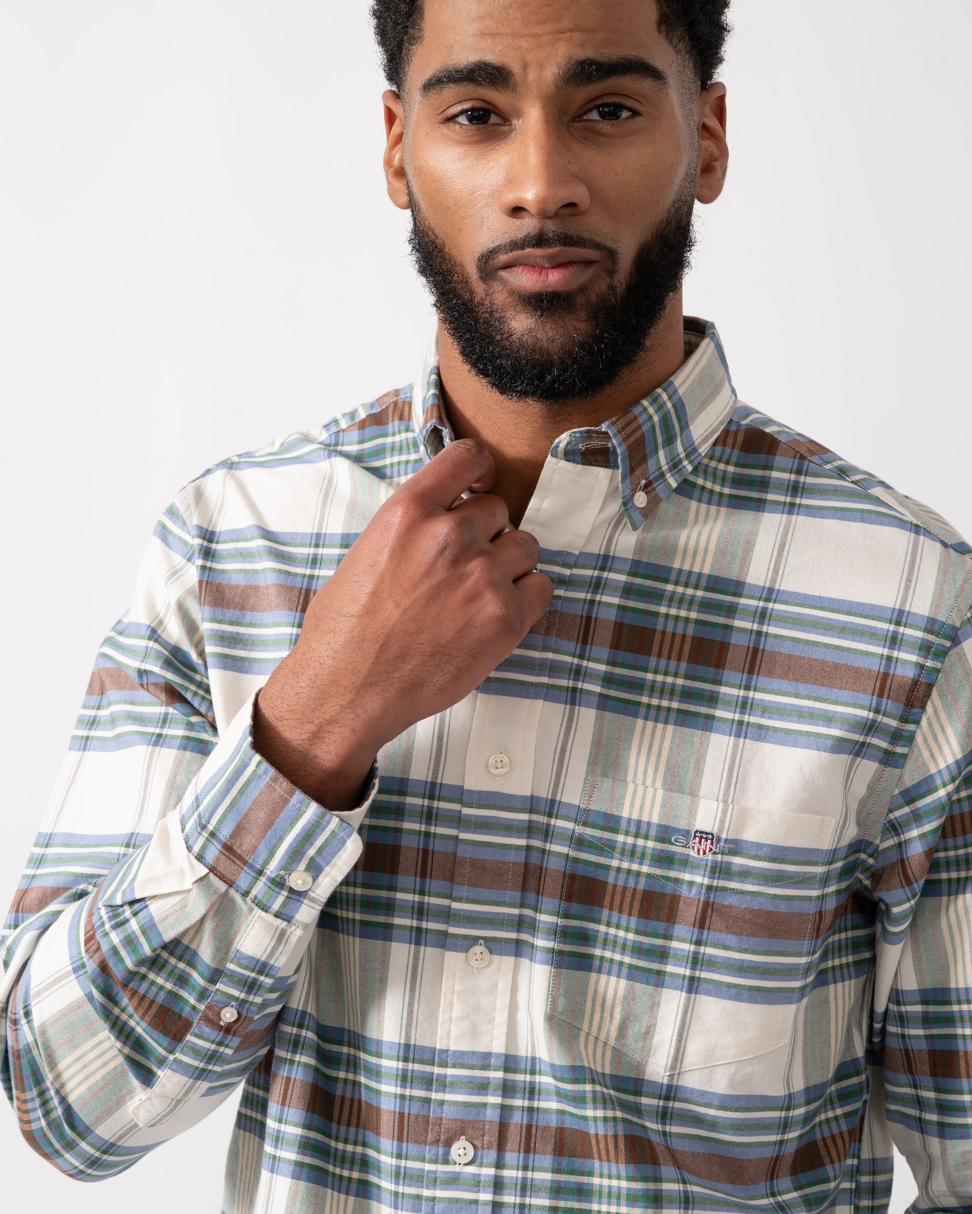 close up shot of a model wearing a GANT Mens Regular Fit Oxford Check Shirt in Woody Green