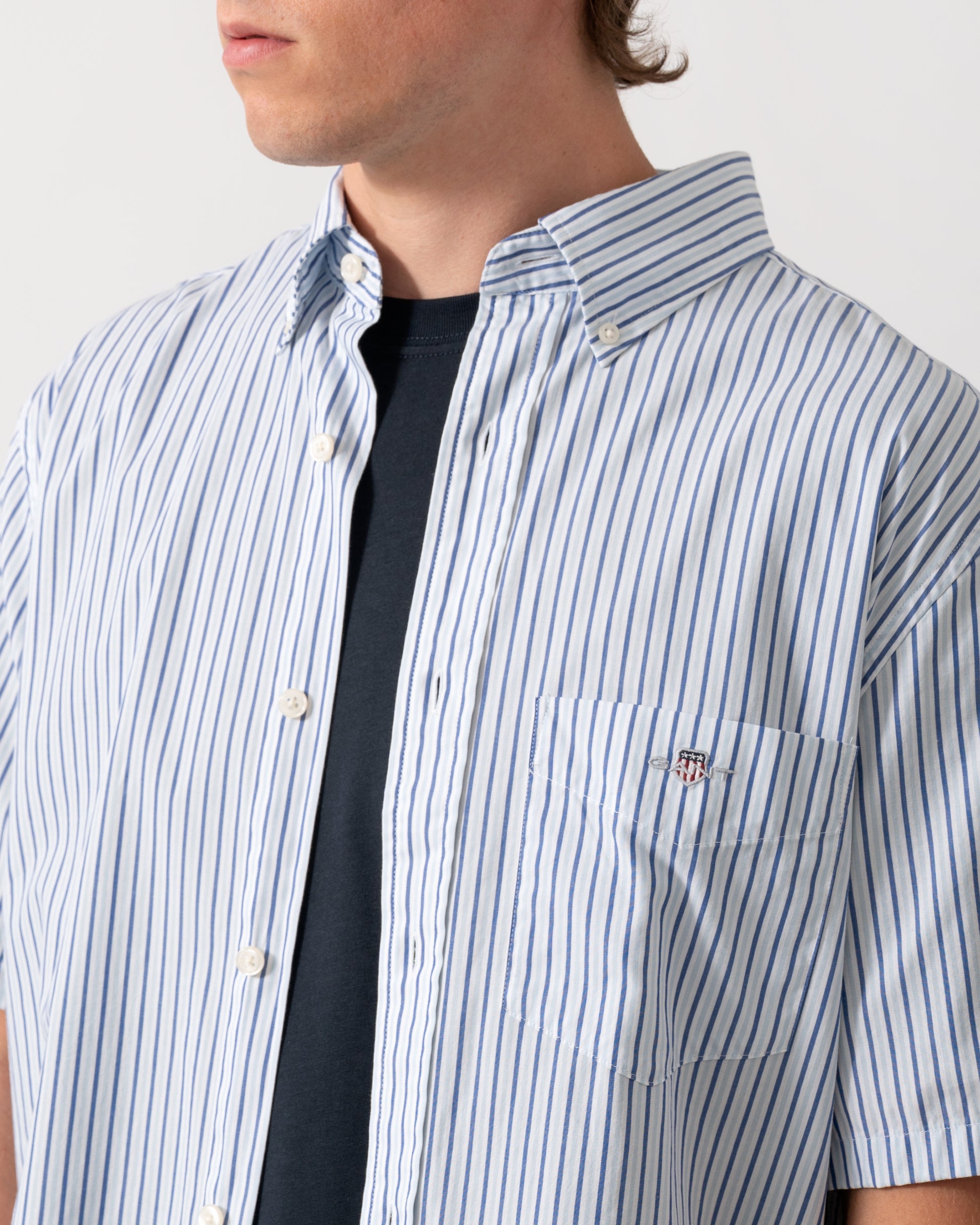detail of a GANT Mens Regular Fit Poplin Stripe Short Sleeve Shirt in 457 Fresh Blue