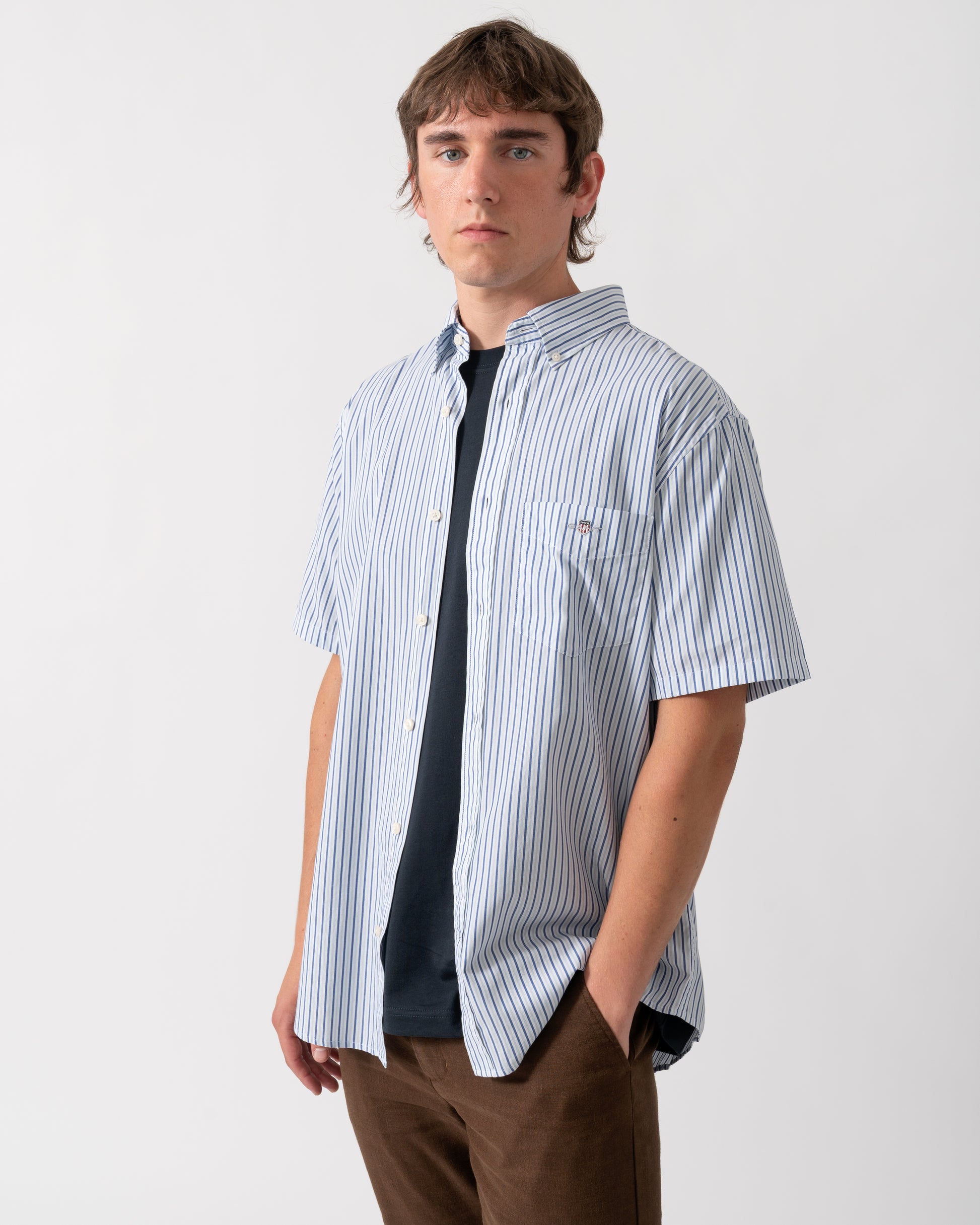model wearing a GANT Mens Regular Fit Poplin Stripe Short Sleeve Shirt in 457 Fresh Blue