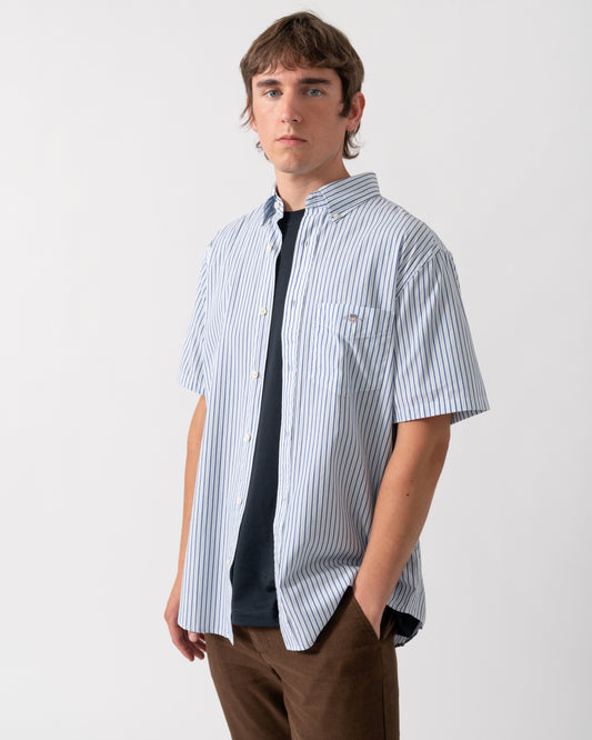 model wearing a GANT Mens Regular Fit Poplin Stripe Short Sleeve Shirt in 457 Fresh Blue