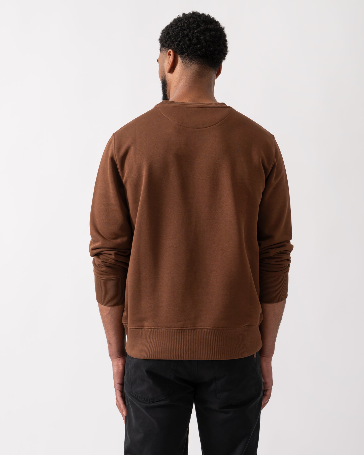 Back shot of a model wearing a GANT Mens Regular Fit Shield Logo Crew Neck Sweatshirt in Mahogany Brown