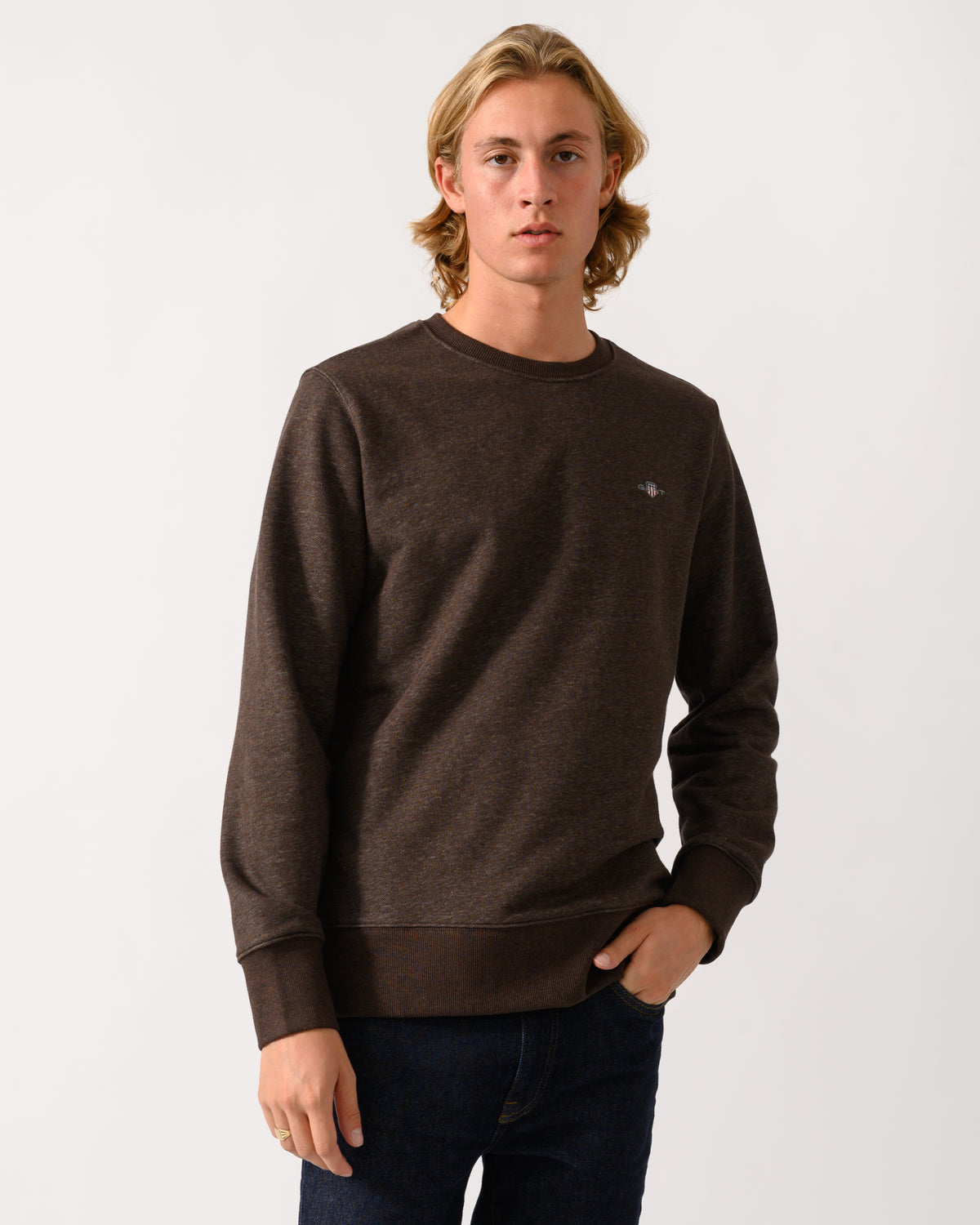 studio photograph of a model wearing a GANT Mens Regular Fit Shield Logo Crew Neck Sweatshirt in 284 Black Brown Melange