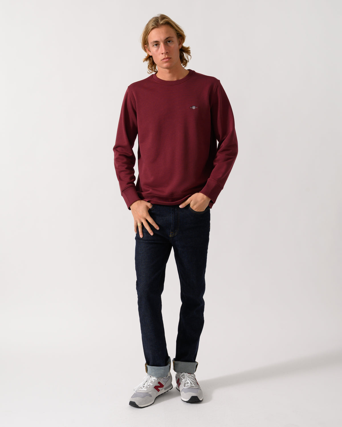 full length of a model wearing a GANT Mens Regular Fit Shield Logo Crew Neck Sweatshirt in 676 Deep Grape Wine