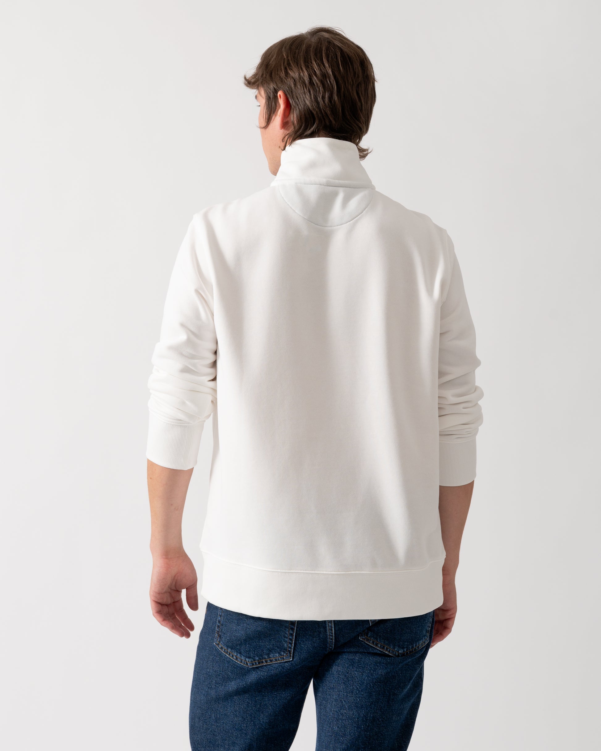 back shot of a model wearing a GANT Mens Regular Fit Shield Logo Half Zip Sweatshirt in 113 Eggshell