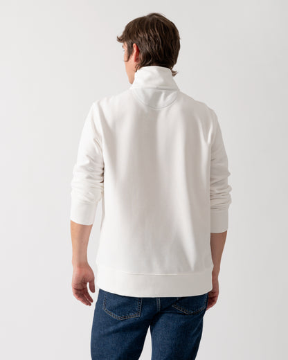 back shot of a model wearing a GANT Mens Regular Fit Shield Logo Half Zip Sweatshirt in 113 Eggshell