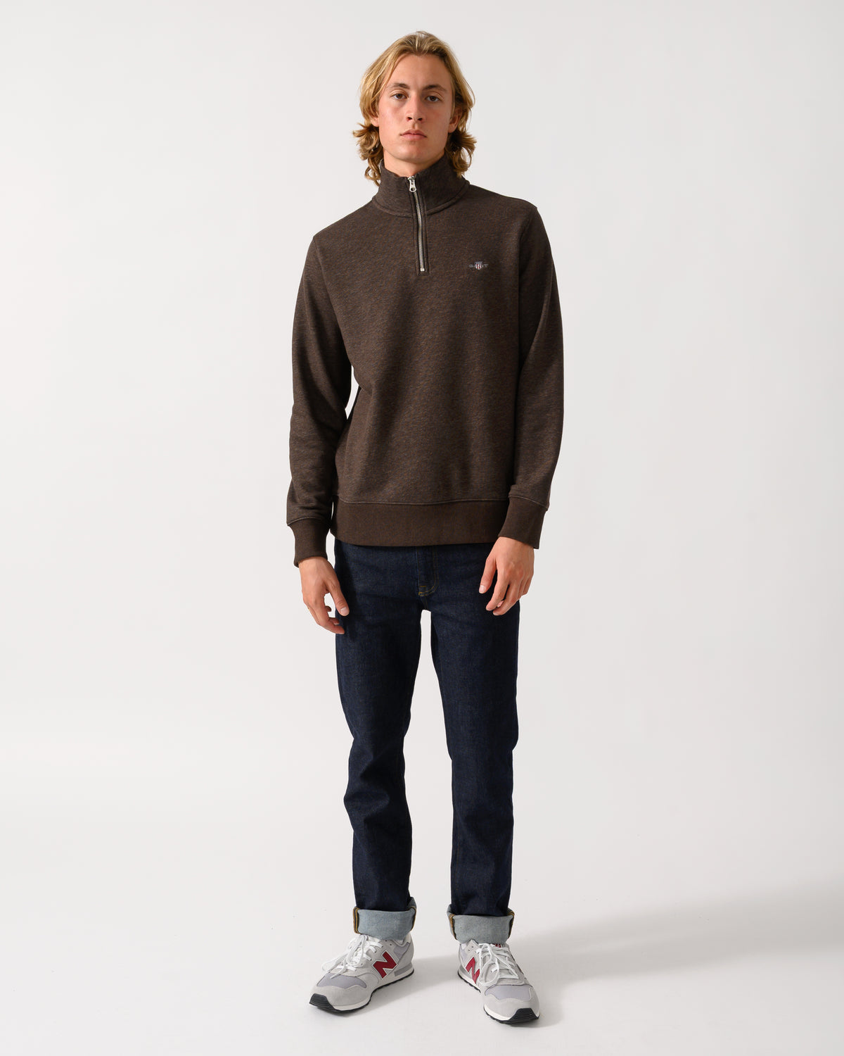 full length of a model wearing a GANT Mens Regular Fit Shield Logo Half Zip Sweatshirt in 284 Black Brown Melange