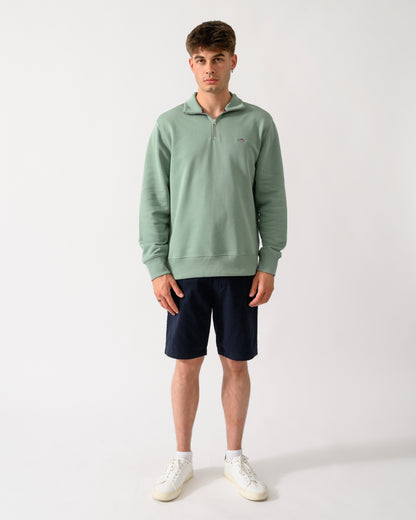 full length shot of a model wearing a GANT Mens Regular Fit Shield Logo Half Zip Sweatshirt in 308 Surplus Mint