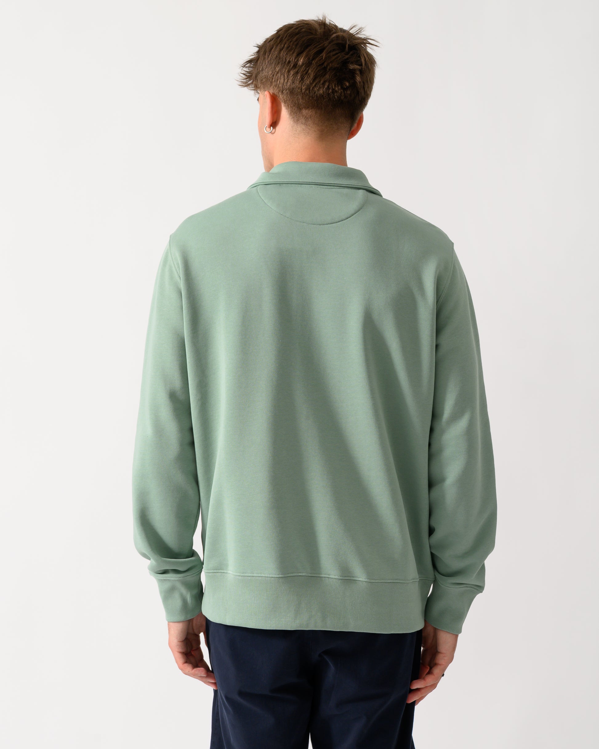 back shot of a model wearing a GANT Mens Regular Fit Shield Logo Half Zip Sweatshirt in 308 Surplus Mint