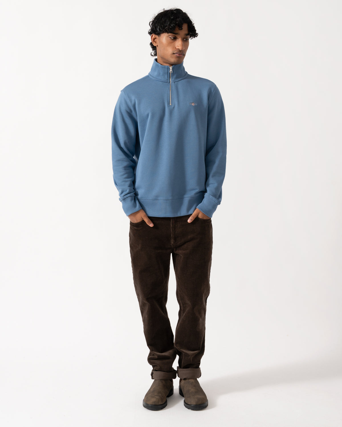 full length Studio photograph of a model wearing a GANT Mens Regular Fit Shield Logo Half Zip Sweatshirt in 476 Blue Horizon
