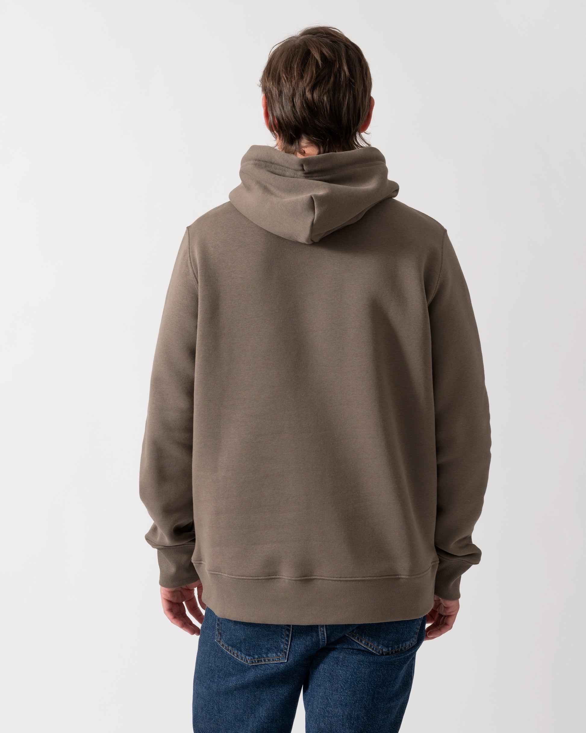 back of model wearing a GANT Mens Regular Fit Shield Logo Pullover Hoodie in 260 Faded Taupe