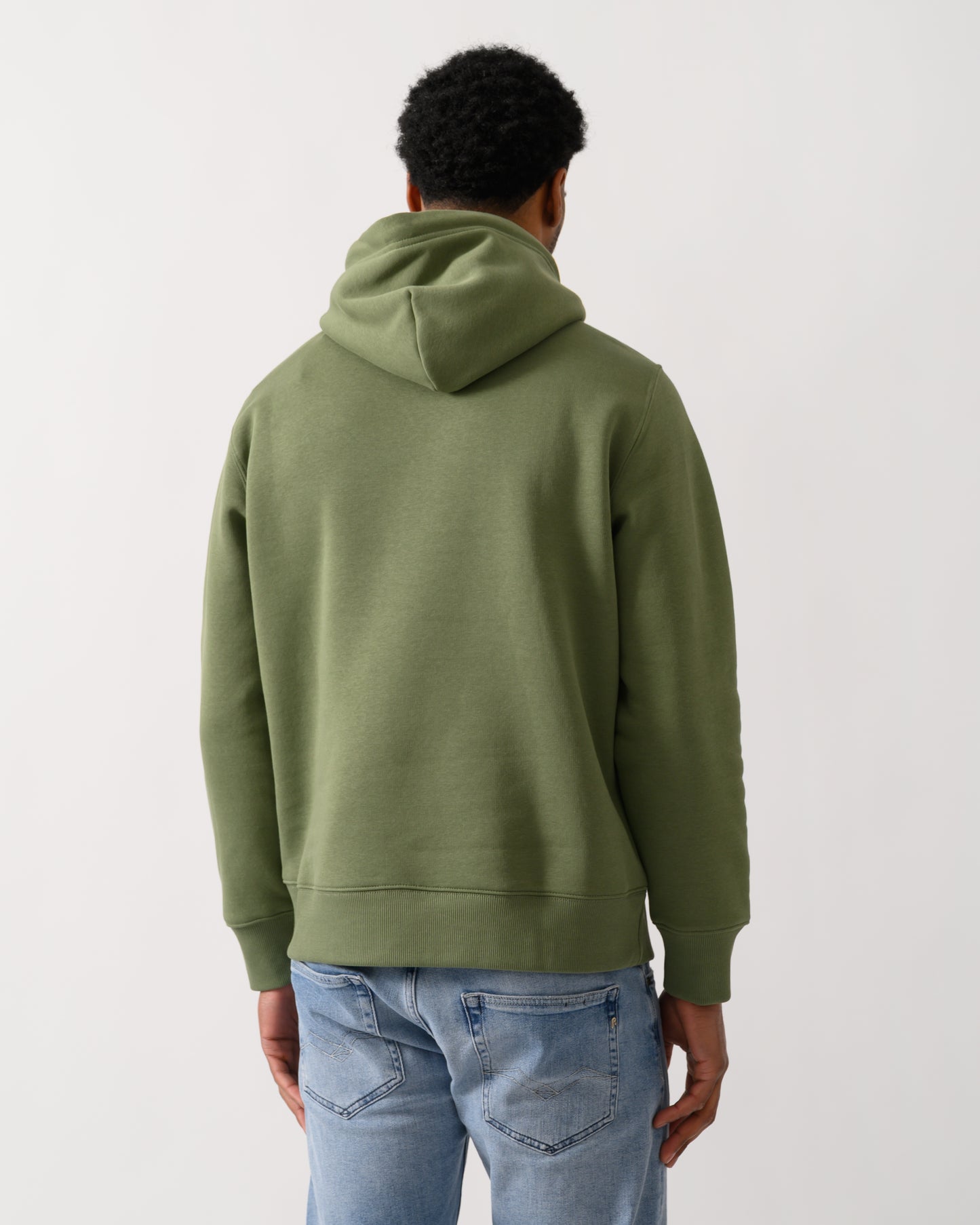 back shot of a model wearing a GANT Mens Regular Fit Shield Logo Pullover Hoodie in 379 Dry Herb Green