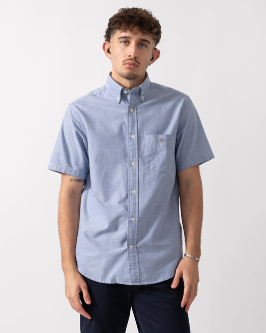 Model wearing a GANT Mens Regular Fit Short Sleeve Oxford Shirt in College Blue