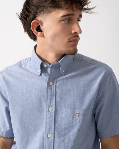 Close up of a Model wearing a GANT Mens Regular Fit Short Sleeve Oxford Shirt in College Blue