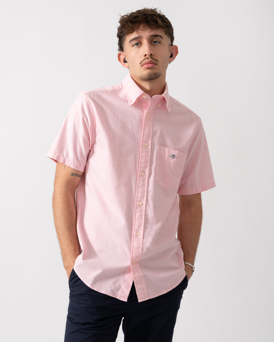 Model wearing a GANT Mens Regular Fit Short Sleeve Oxford Shirt in Washed Pink