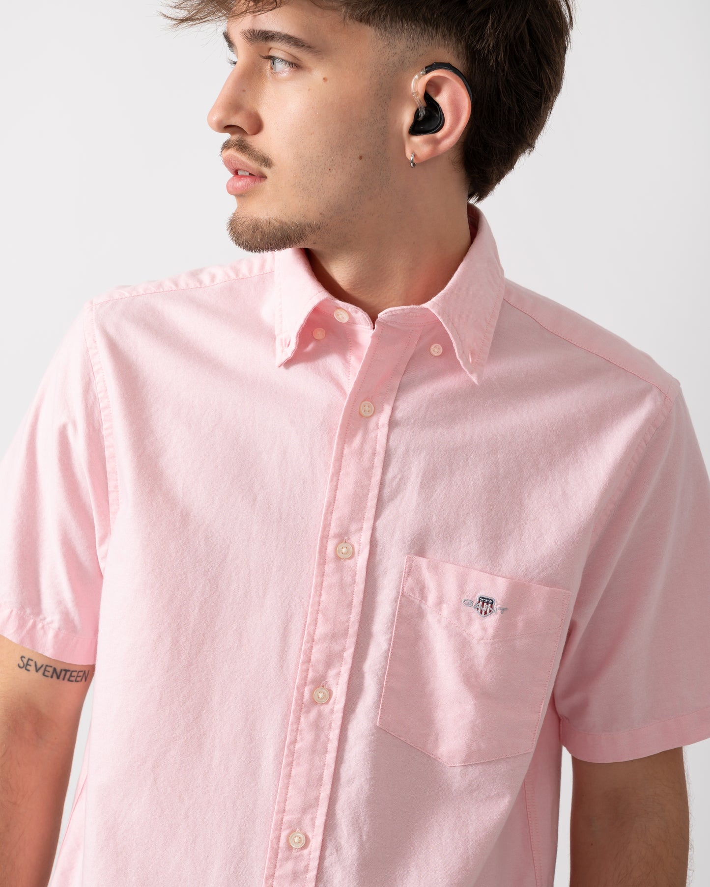 Close up of a Model wearing a GANT Mens Regular Fit Short Sleeve Oxford Shirt in Washed Pink