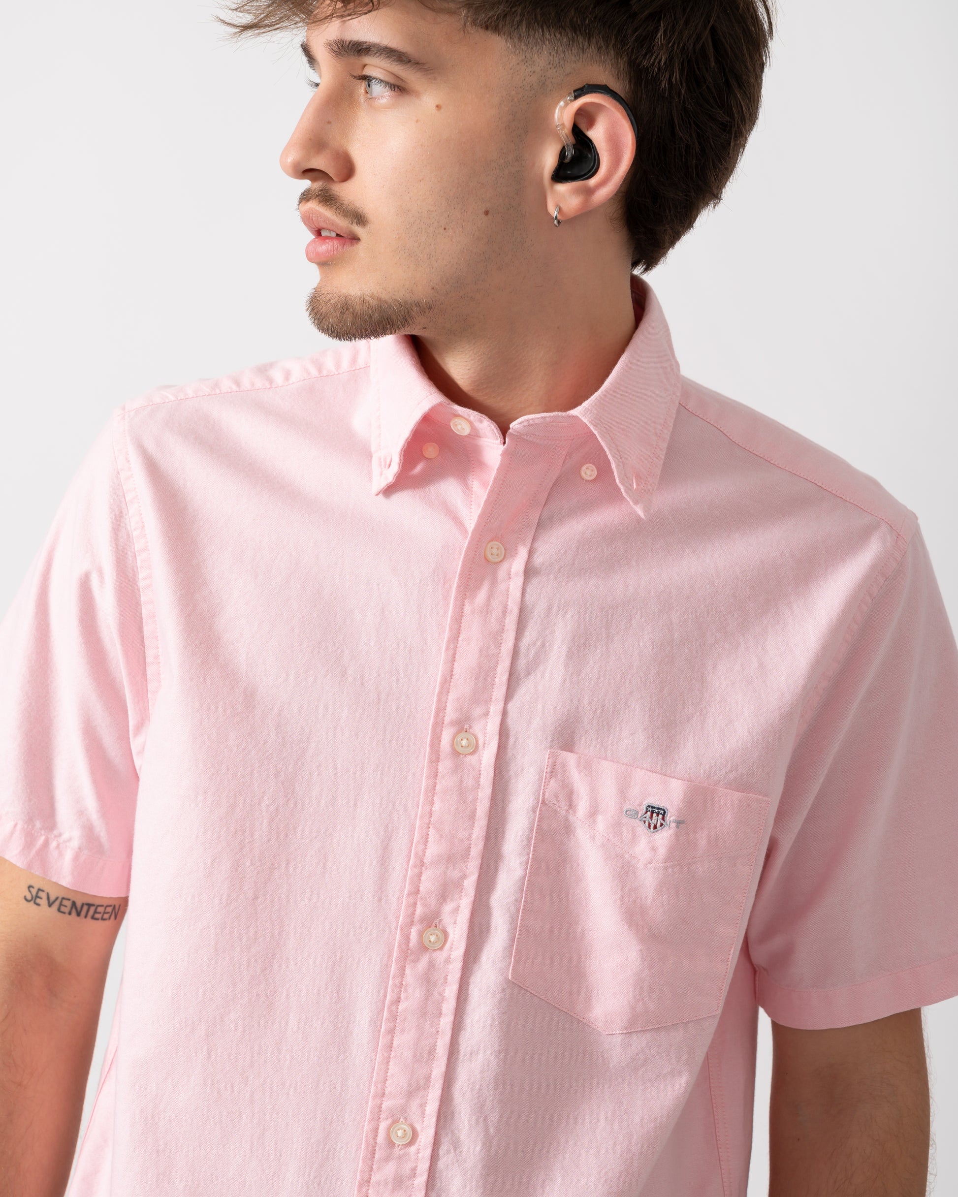 Close up of a Model wearing a GANT Mens Regular Fit Short Sleeve Oxford Shirt in Washed Pink