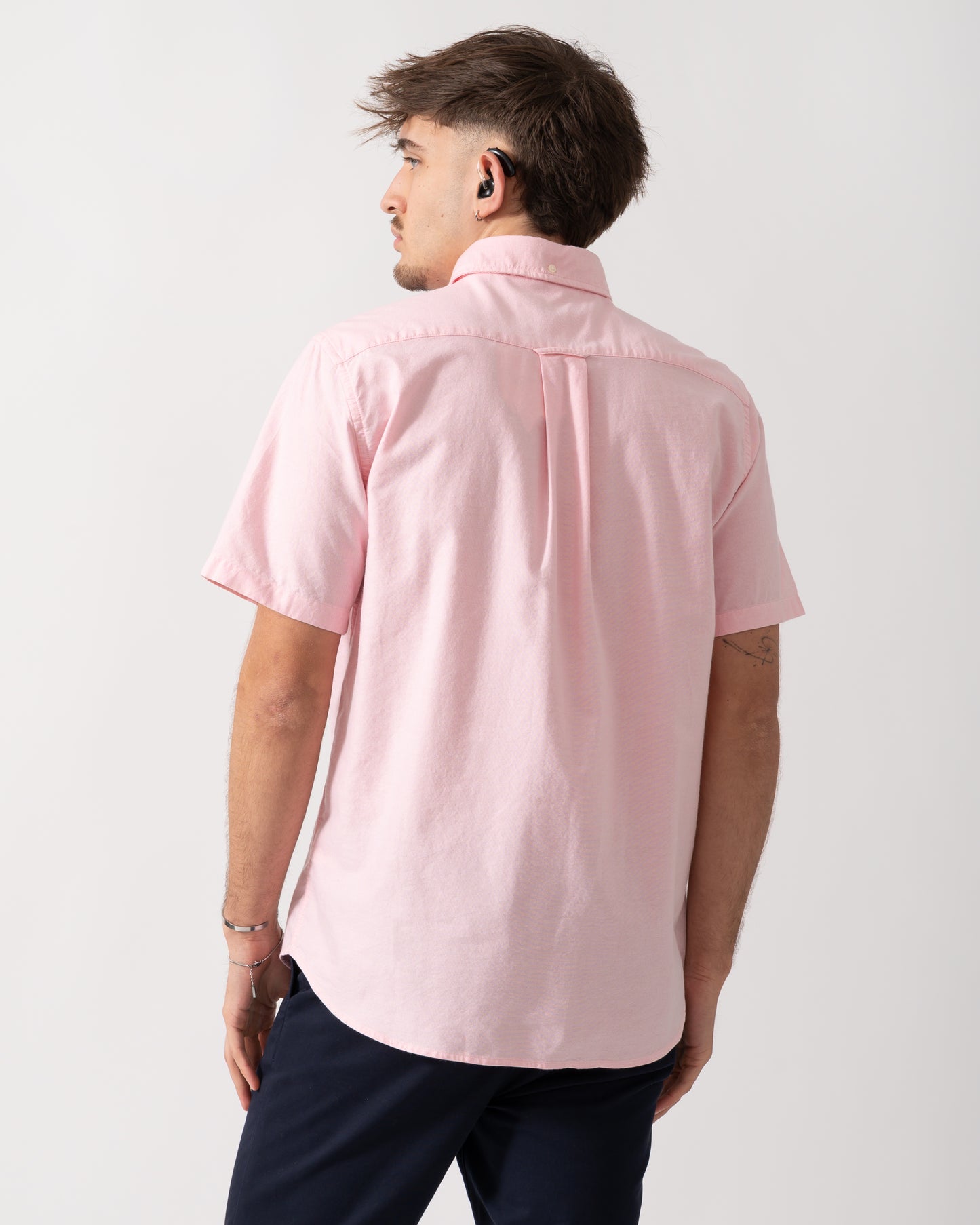 back shot of a Model wearing a GANT Mens Regular Fit Short Sleeve Oxford Shirt in Washed Pink