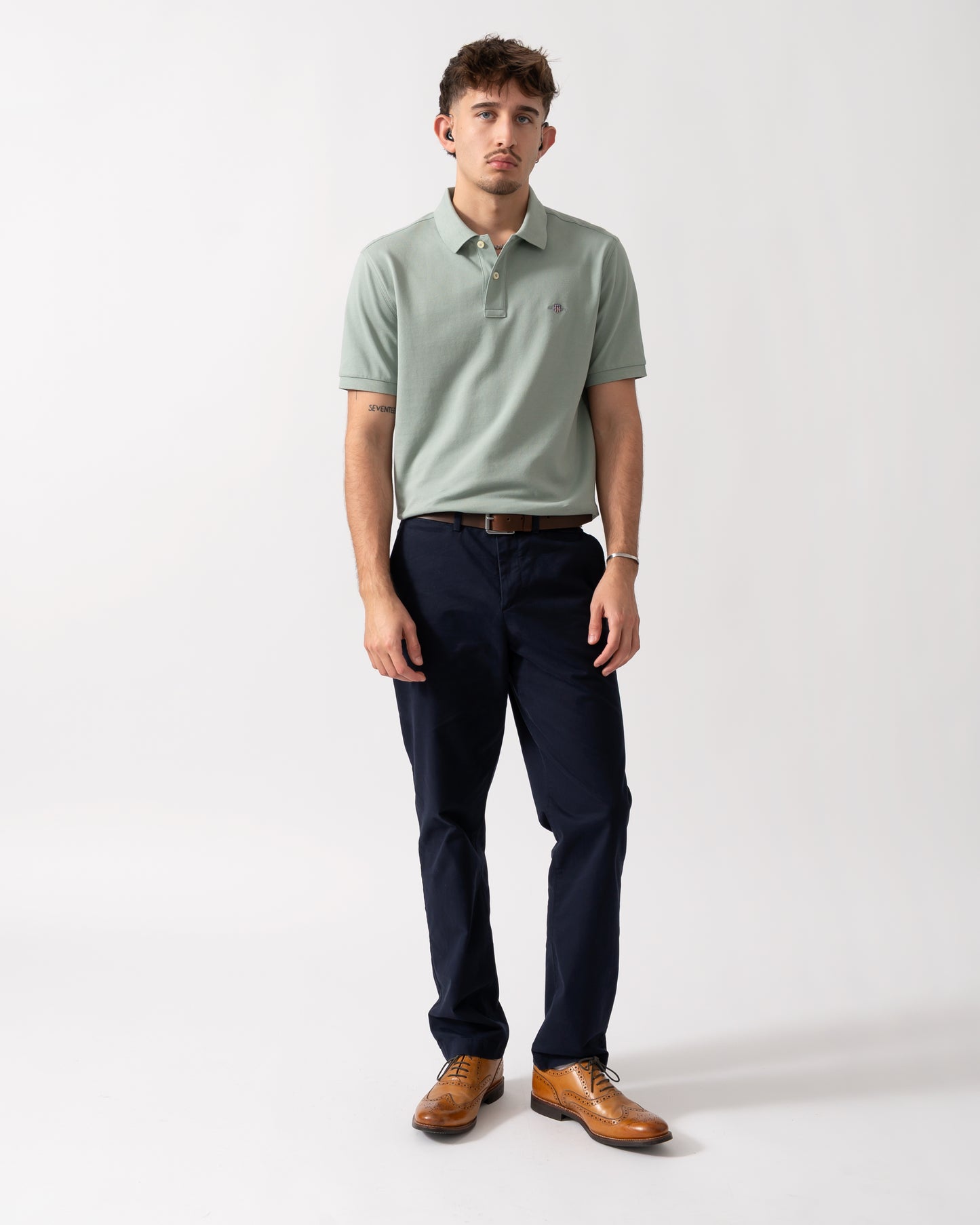 Full length shot of a Model wearing a GANT Mens Regular Fit Short Sleeve Shield Logo Pique Polo in Ceramic Grey