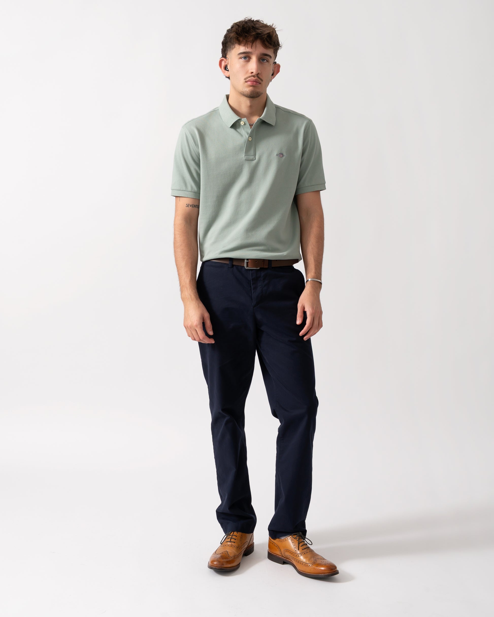 Full length shot of a Model wearing a GANT Mens Regular Fit Short Sleeve Shield Logo Pique Polo in Ceramic Grey