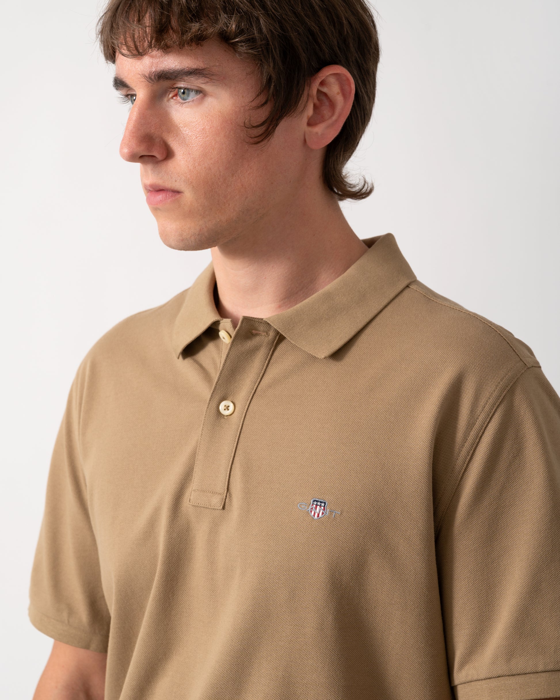 close up of GANT Mens Regular Fit Short Sleeve Shield Logo Pique Polo in 264 Light Taupe