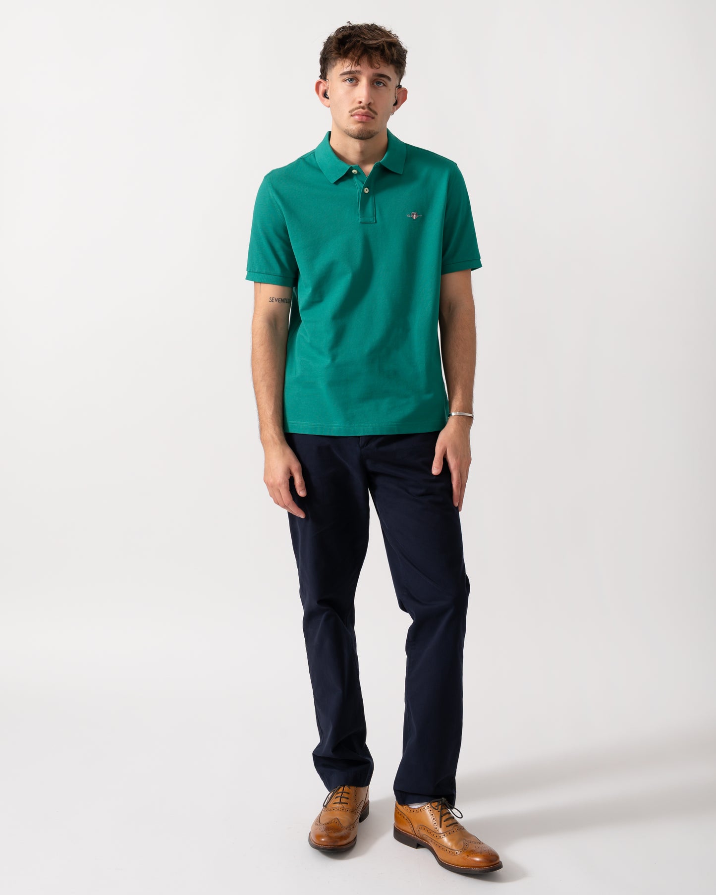 Full length shot of a Model wearing a GANT Mens Regular Fit Short Sleeve Shield Logo Pique Polo in Botanical Hue