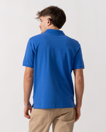 back shot of a Model wearing a GANT Mens Regular Fit Short Sleeve Shield Logo Pique Polo in Royal Blue