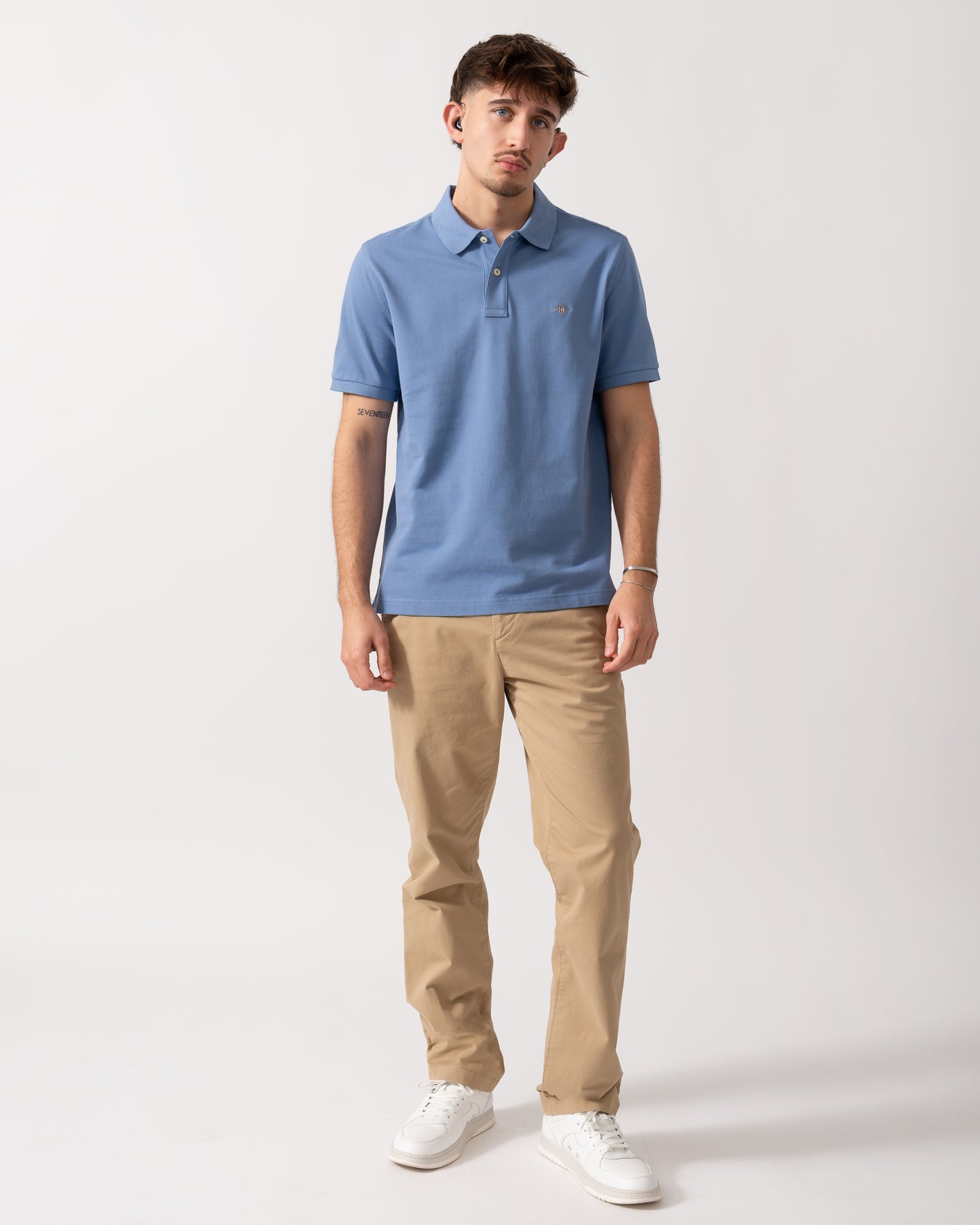 Full length shot of a Model wearing a GANT Mens Regular Fit Short Sleeve Shield Logo Pique Polo in Faded Denim