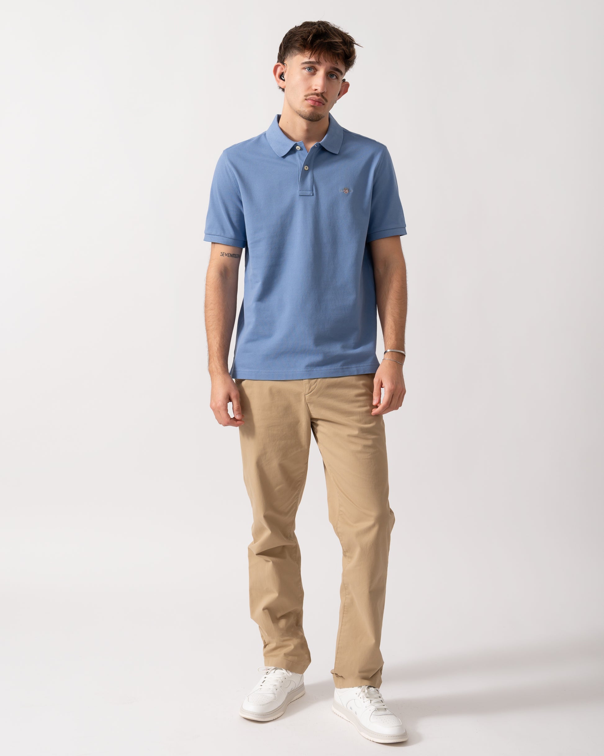 Full length shot of a Model wearing a GANT Mens Regular Fit Short Sleeve Shield Logo Pique Polo in Faded Denim