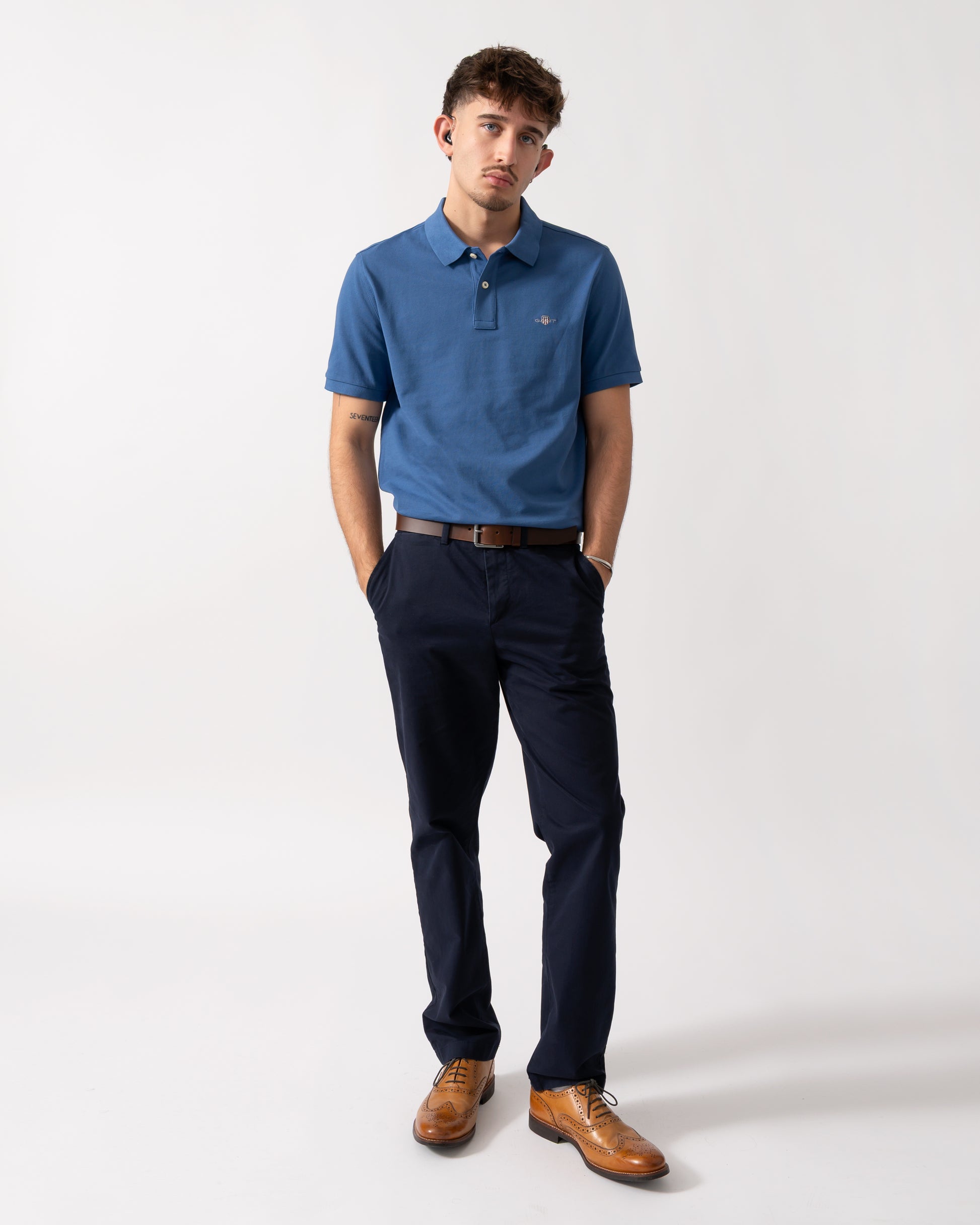 Full length shot of a Model wearing a GANT Mens Regular Fit Short Sleeve Shield Logo Pique Polo in Vintage Blue