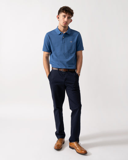 Full length shot of a Model wearing a GANT Mens Regular Fit Short Sleeve Shield Logo Pique Polo in Vintage Blue