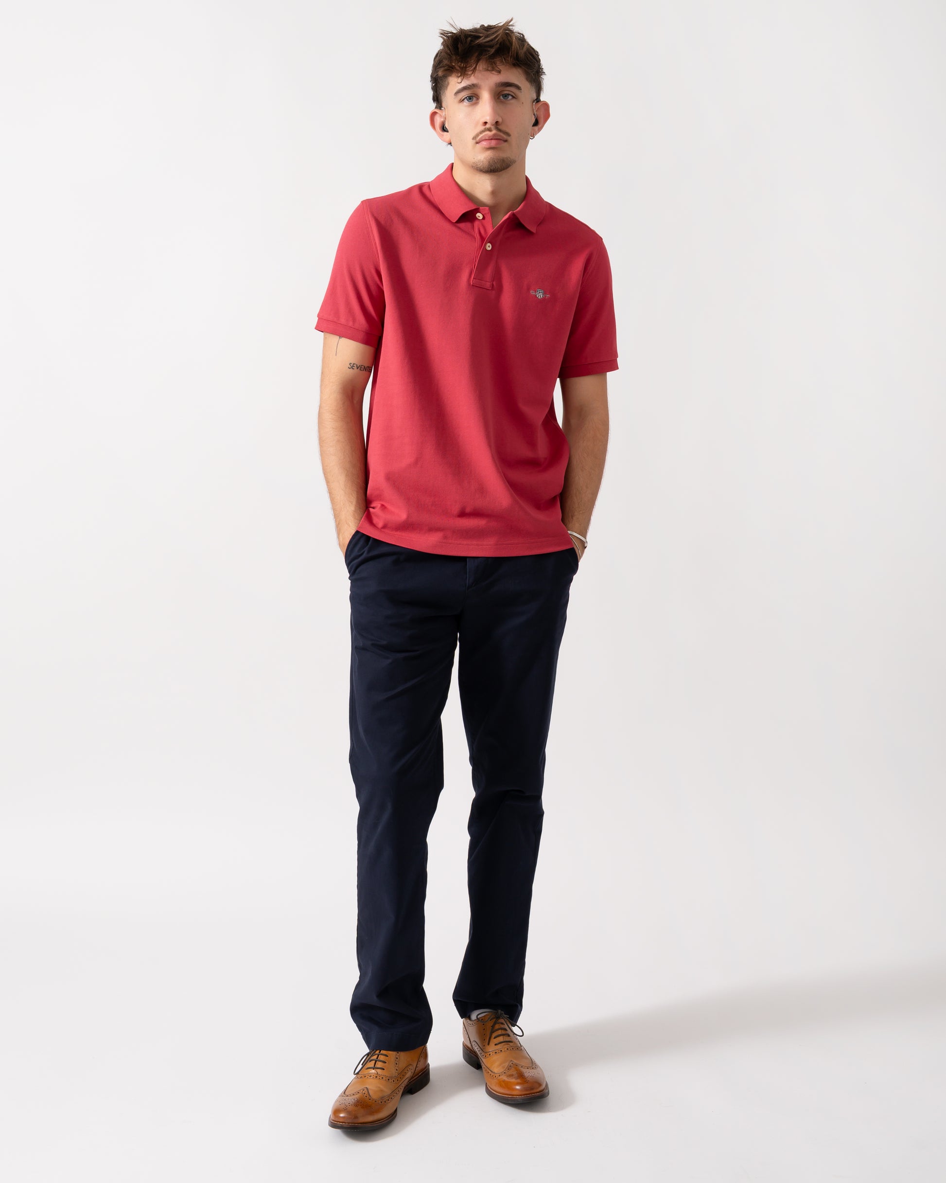 Lull length shot of a Model wearing a GANT Mens Regular Fit Short Sleeve Shield Logo Pique Polo in Muted Red